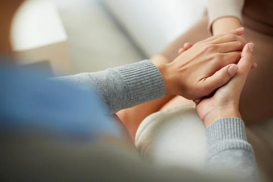 Supportive hands during a one-to-one counseling session